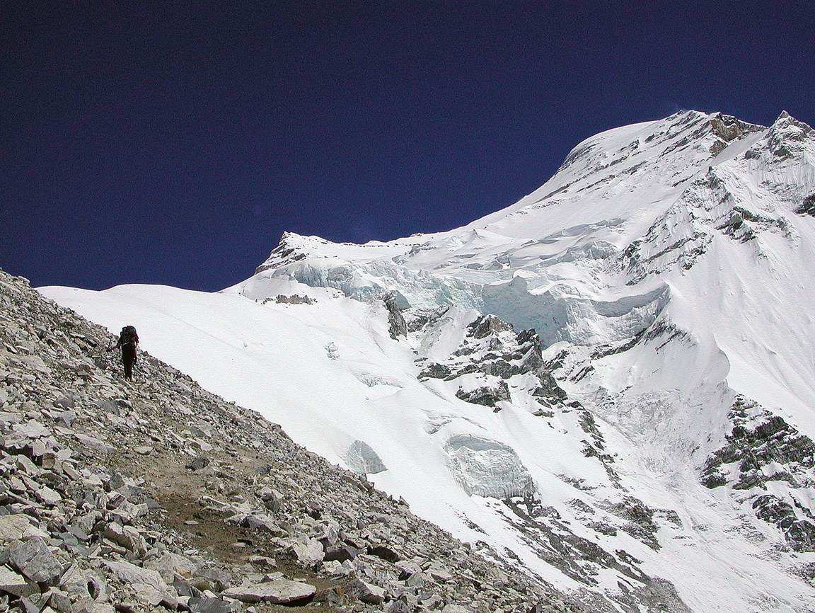 A person walking on a mountain

Description automatically generated