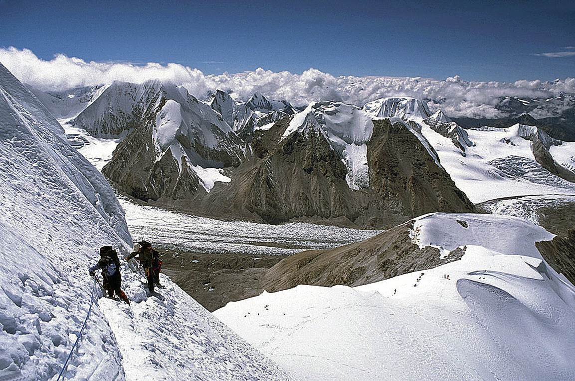 A group of people climbing a mountain

Description automatically generated