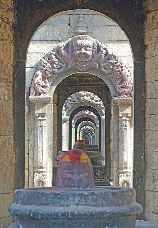 Stone archways with stone carvings

Description automatically generated