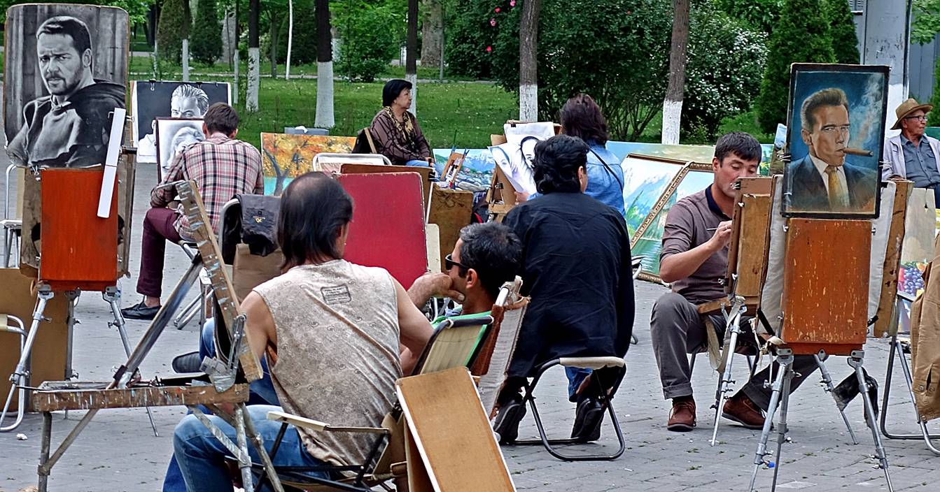 A group of people painting outside

Description automatically generated