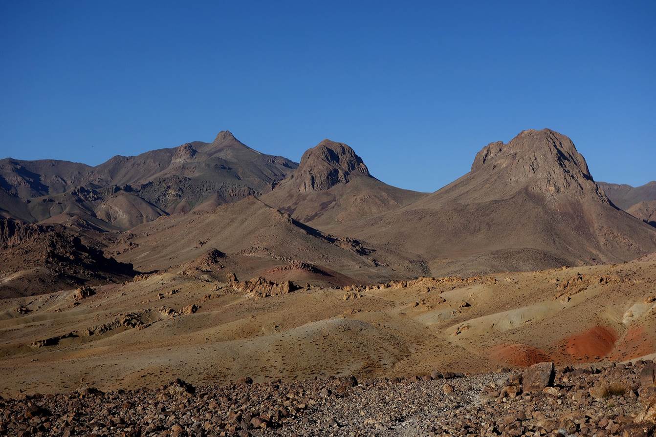 A desert landscape with mountains and blue sky

Description automatically generated