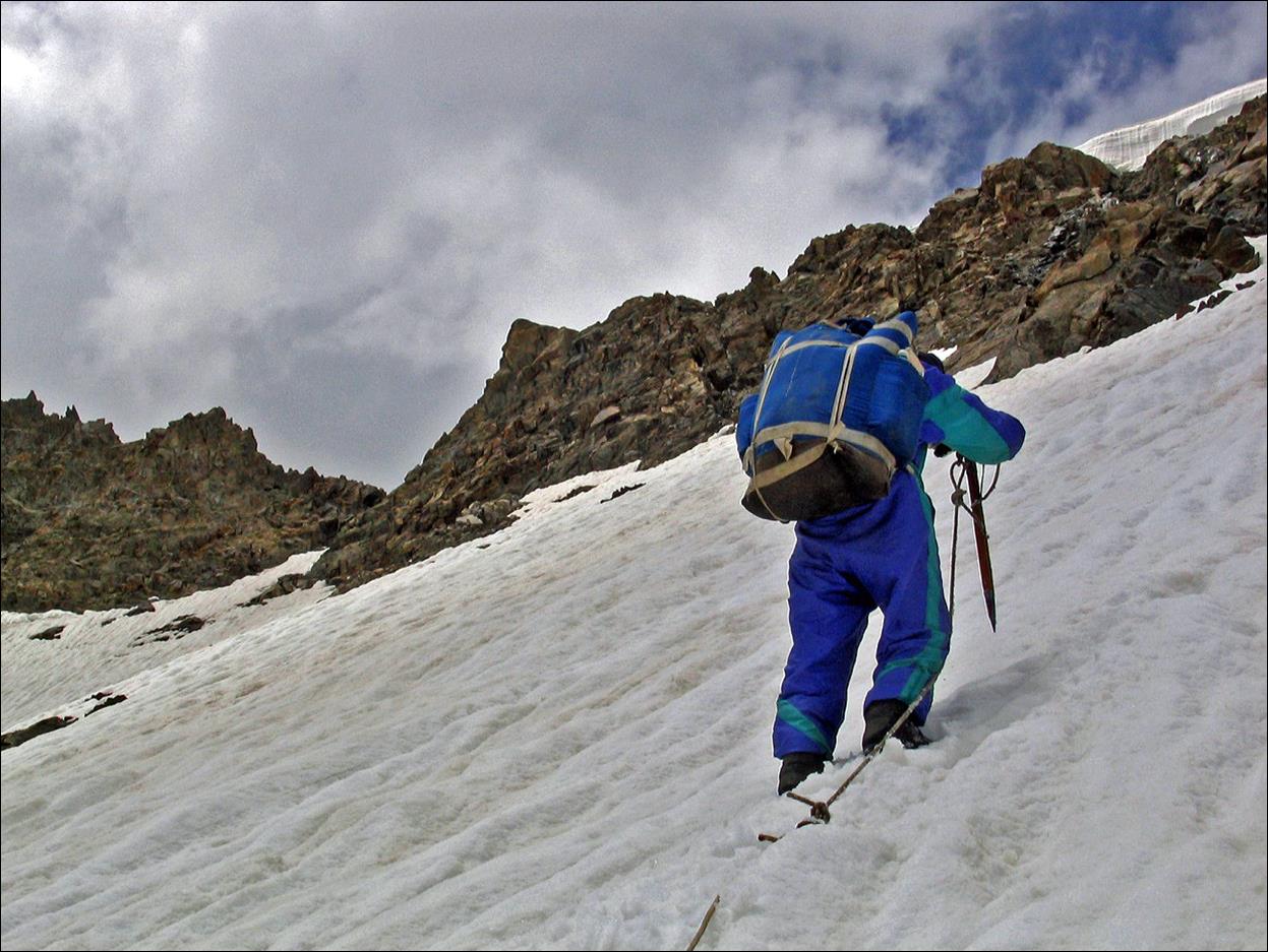 A person climbing a snowy mountain

Description automatically generated