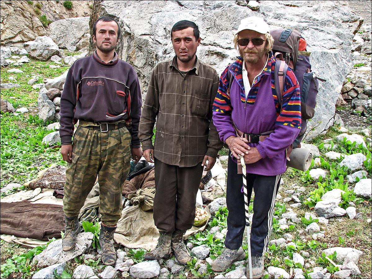A group of men standing in a rocky area

Description automatically generated