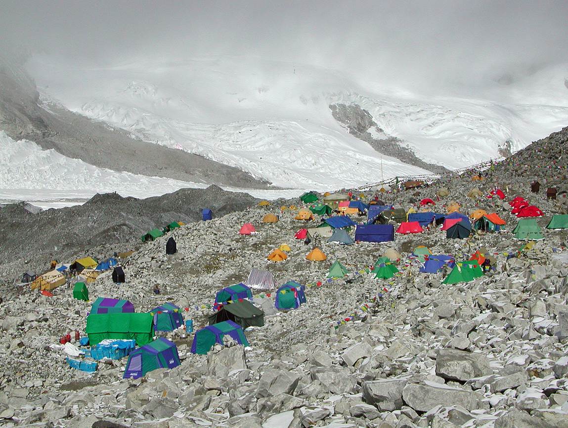 A group of tents on a rocky mountain

Description automatically generated