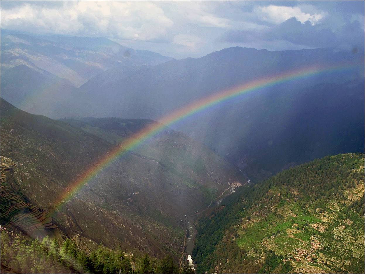 A rainbow over a valley

Description automatically generated