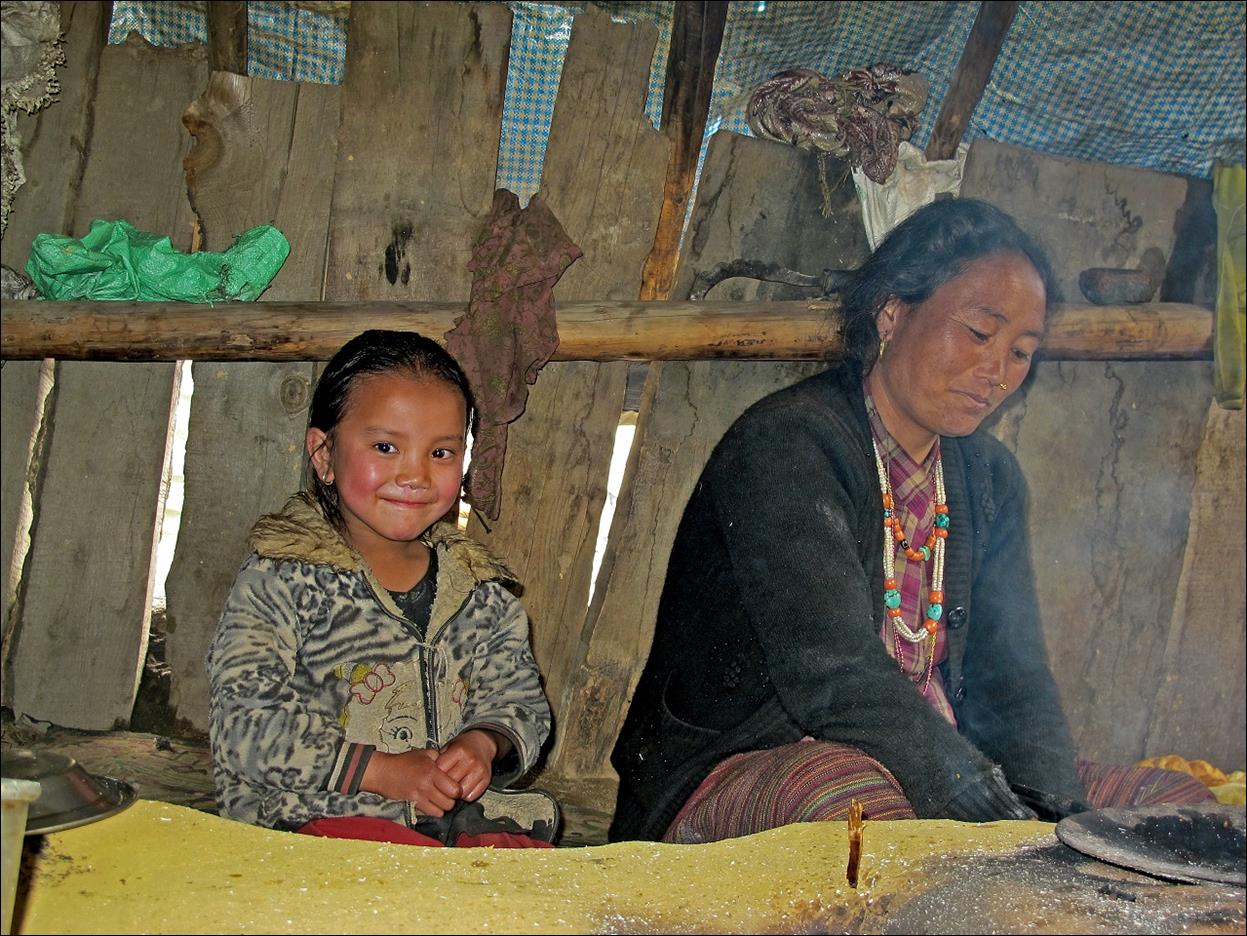 A person and a child in a hut

Description automatically generated