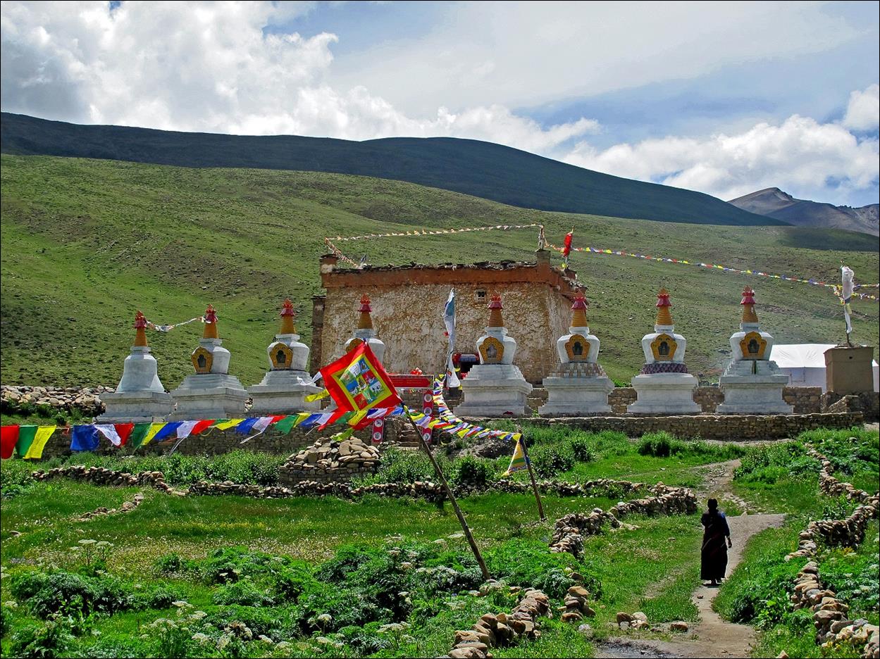 A group of white pagodas in a field

Description automatically generated