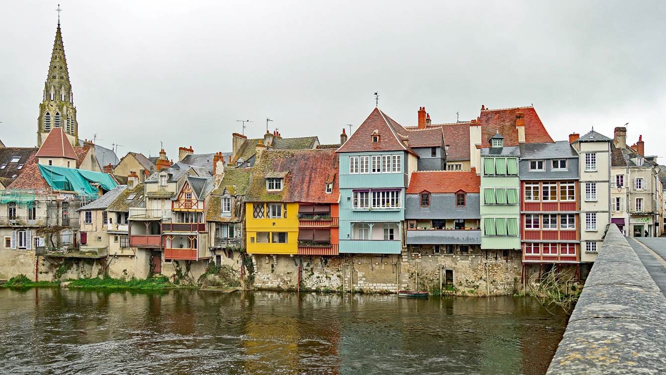 A row of colorful buildings next to a body of water

Description automatically generated with medium confidence