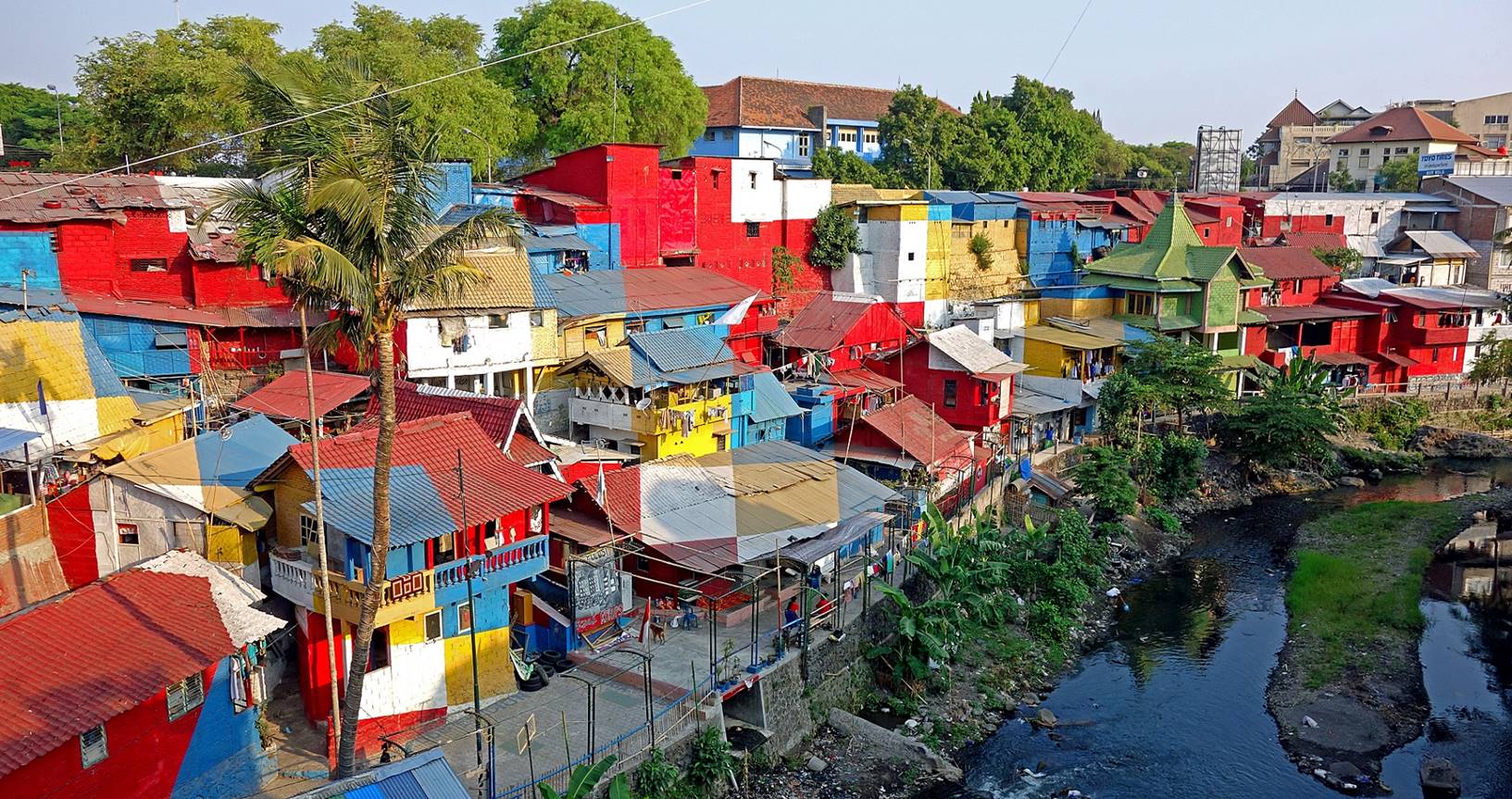 A colorful buildings along a river

Description automatically generated