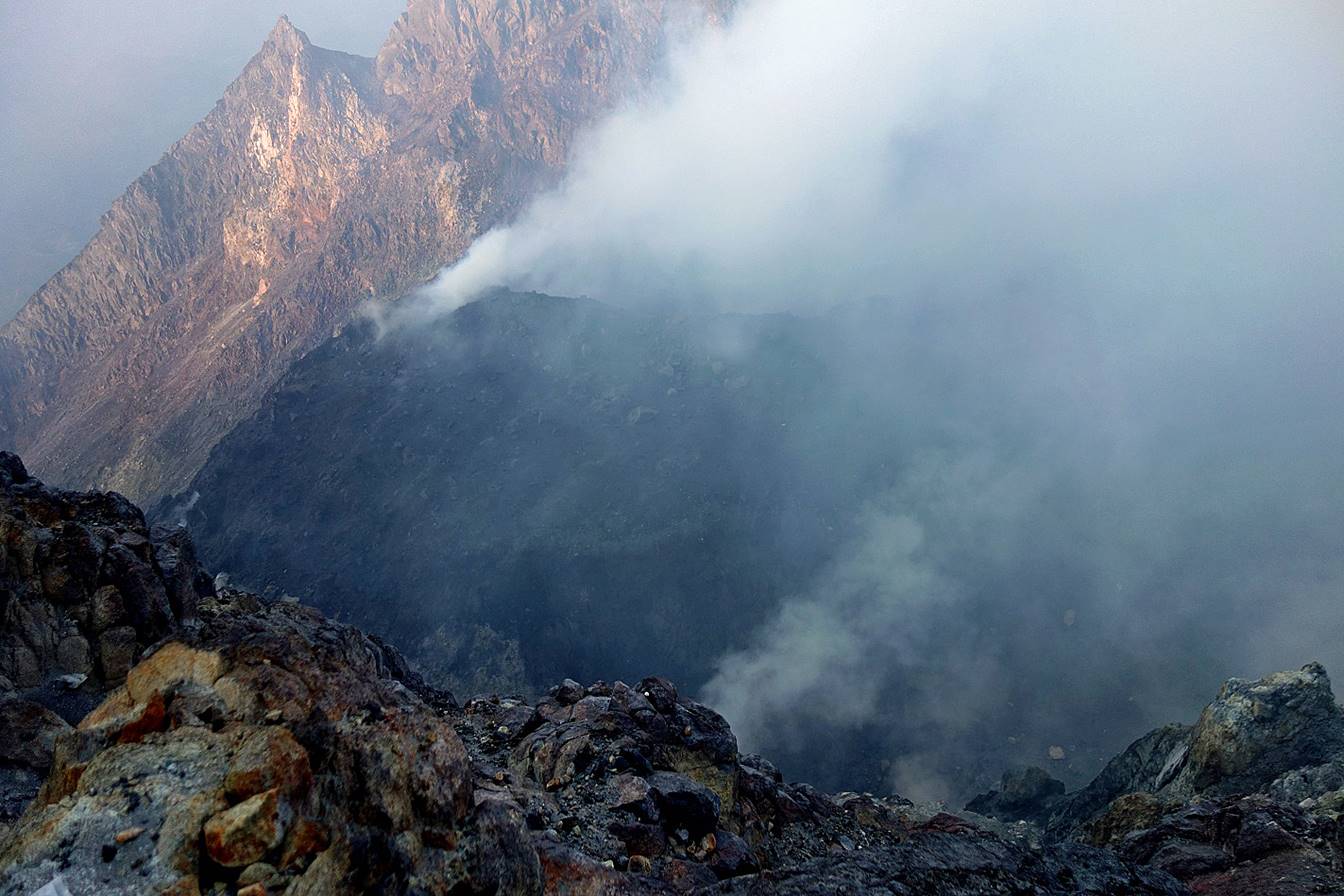 A mountain with smoke coming out of it

Description automatically generated