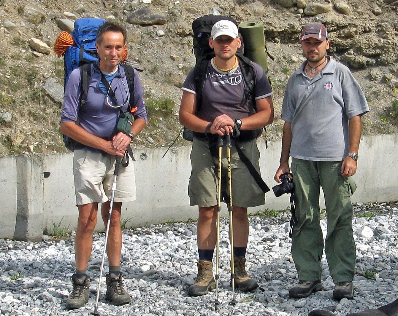 A group of men with backpacks and poles

Description automatically generated