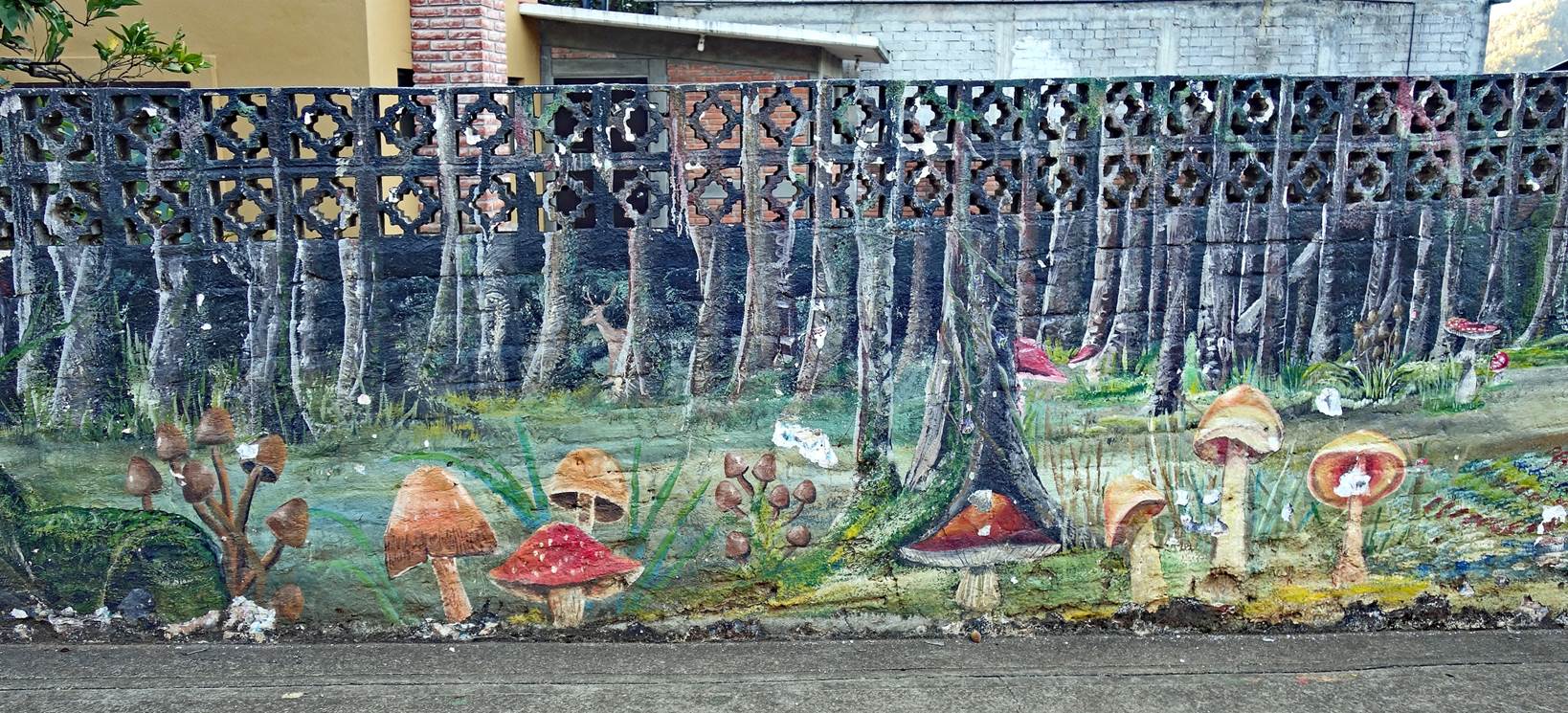A painted fence with trees and mushrooms

Description automatically generated