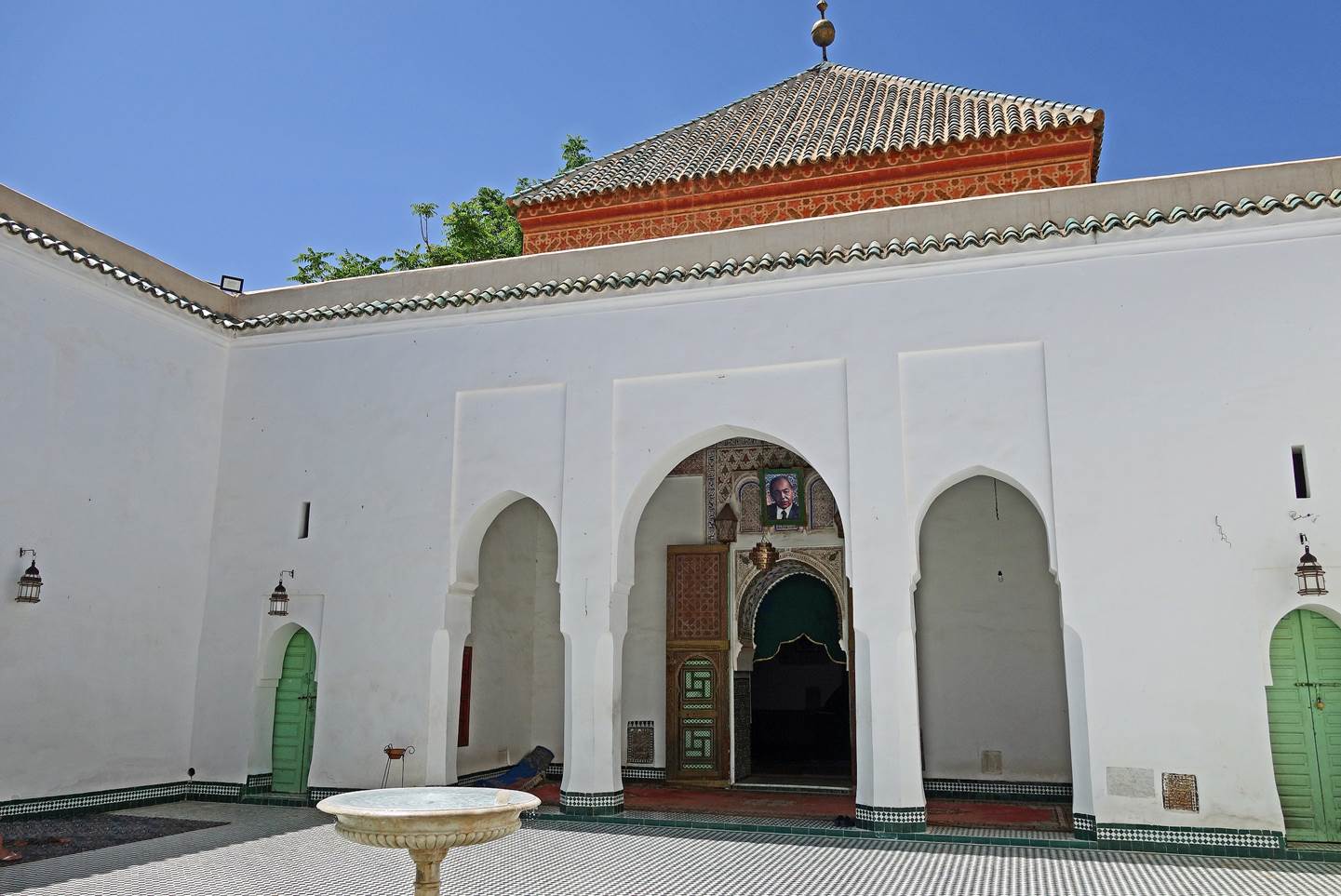 A white building with arched doorways

Description automatically generated with low confidence